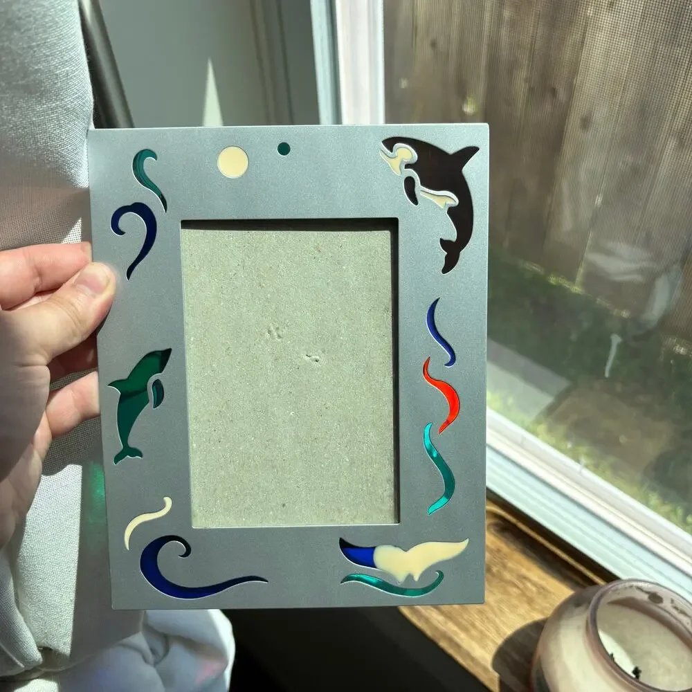 Vintage metal frame with dolphin and orca colorful designs